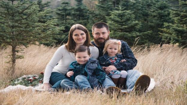 family photo sitting on grass field